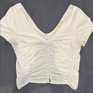 URBAN OUTFITTERS light blue cropped, ruched, v neck short-sleeve t-shirt. Size S